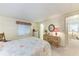 Comfortable bedroom with carpet floors has a dresser and mirror plus a view of the bathroom at 5619 Bayshore Rd # 203, Palmetto, FL 34221