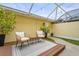 Enclosed back patio featuring stylish outdoor furniture and decorative plants at 5646 Simonton St, Bradenton, FL 34203