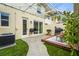 Inviting backyard with outdoor seating, a grill, and lush artificial turf at 5646 Simonton St, Bradenton, FL 34203