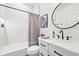 Modern bathroom with sleek black fixtures and tiled shower/tub combination at 5646 Simonton St, Bradenton, FL 34203