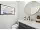 Stylish half bath with round mirror, modern fixtures, and elegant vanity at 5646 Simonton St, Bradenton, FL 34203