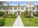 Beautiful townhome with manicured landscaping, charming shutters, and a welcoming walkway at 5646 Simonton St, Bradenton, FL 34203