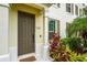 Close-up of the inviting front door with house number, complemented by lush landscaping at 5646 Simonton St, Bradenton, FL 34203