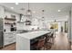 Modern kitchen boasts an expansive island, stainless steel appliances, and stylish pendant lighting at 5646 Simonton St, Bradenton, FL 34203