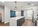 Bright open kitchen with island, pendant lights, and modern appliances at 5646 Simonton St, Bradenton, FL 34203