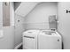 Efficient laundry room with washer, dryer, and storage shelf for convenience at 5646 Simonton St, Bradenton, FL 34203