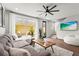 Cozy living room featuring a comfortable sectional sofa and a seamless transition to the outdoor patio at 5646 Simonton St, Bradenton, FL 34203