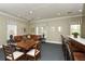 Cozy lounge area with a comfortable leather couch, chairs, and a small bar area at 5646 Simonton St, Bradenton, FL 34203