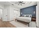 Serene main bedroom with a striking accent wall, elegant lighting, and a barn door to the ensuite at 5646 Simonton St, Bradenton, FL 34203