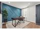 Home office with a decorative accent wall, modern desk, and natural light at 5646 Simonton St, Bradenton, FL 34203
