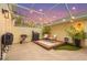 Relaxing outdoor patio area featuring comfortable seating, a grill, and ambient string lights at 5646 Simonton St, Bradenton, FL 34203