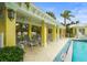A covered area next to the pool, offering lounge chairs and a relaxing spot in the community at 5646 Simonton St, Bradenton, FL 34203