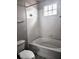 Bright bathroom with a white tiled shower-tub combination and a window providing natural light at 5711 Bentgrass Dr # 19-203, Sarasota, FL 34235