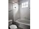 A clean and simple bathroom featuring a bathtub, shower, and white tile surround at 5711 Bentgrass Dr # 19-203, Sarasota, FL 34235