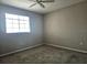 Neutral bedroom with carpet, ceiling fan, and a window providing natural light at 5711 Bentgrass Dr # 19-203, Sarasota, FL 34235