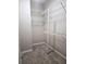 Walk-in closet featuring carpeted floors and wire shelving for ample storage at 5711 Bentgrass Dr # 19-203, Sarasota, FL 34235