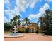Community clubhouse surrounded by palm trees and featuring a lovely fountain entrance at 5711 Bentgrass Dr # 19-203, Sarasota, FL 34235
