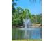 Picturesque fountain nestled within a serene pond surrounded by lush greenery at 5711 Bentgrass Dr # 19-203, Sarasota, FL 34235