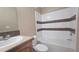 This bathroom offers a tub-shower combo with tiled walls and a functional vanity at 6238 Angus Valley Dr, Wesley Chapel, FL 33544