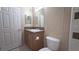 A well-lit bathroom features a toilet, sink, vanity, and a mirrored medicine cabinet at 6238 Angus Valley Dr, Wesley Chapel, FL 33544