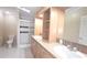 Bathroom featuring a double vanity, tiled floor, and glass-enclosed shower at 6238 Angus Valley Dr, Wesley Chapel, FL 33544