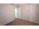 This carpeted bedroom offers neutral walls and multiple doorways, creating an airy atmosphere at 6238 Angus Valley Dr, Wesley Chapel, FL 33544