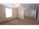 A carpeted bedroom with neutral walls; a window provides ample natural light at 6238 Angus Valley Dr, Wesley Chapel, FL 33544
