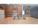 Spacious kitchen features a large island with a double sink, wood cabinets, and modern appliances at 6238 Angus Valley Dr, Wesley Chapel, FL 33544