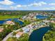 Aerial view showing waterfront home surrounded by lush landscaping and waterways at 6406 Lincoln Rd, Bradenton, FL 34203