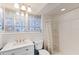 Bright bathroom with white vanity, toilet, and shower with curtain at 6406 Lincoln Rd, Bradenton, FL 34203