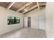 Bedroom with tiled floors, neutral walls, beamed ceiling, and ensuite bathroom access at 6406 Lincoln Rd, Bradenton, FL 34203