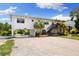 Charming waterfront home boasting ample parking, lovely landscaping, and convenient under-house access at 6406 Lincoln Rd, Bradenton, FL 34203