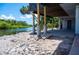 Exterior of home showing concrete supports and a waterfront view surrounded by lush greenery at 6406 Lincoln Rd, Bradenton, FL 34203