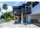 Charming home exterior with a waterfront view, elevated deck, and access to the lower level at 6406 Lincoln Rd, Bradenton, FL 34203