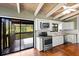 Bright kitchen with stainless steel appliances, white cabinets, and view to covered porch overlooking the water at 6406 Lincoln Rd, Bradenton, FL 34203