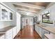 Open kitchen with white cabinets, stainless appliances, and beamed ceilings at 6406 Lincoln Rd, Bradenton, FL 34203