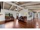 Open living space features hardwood floors, beamed ceilings, and seamless transition to the kitchen at 6406 Lincoln Rd, Bradenton, FL 34203