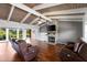 Inviting living room featuring a stone fireplace, wood-beamed ceilings, and expansive views of the waterfront at 6406 Lincoln Rd, Bradenton, FL 34203
