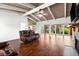 Spacious living room with hardwood floors, beamed ceilings, and large windows offering scenic outdoor views at 6406 Lincoln Rd, Bradenton, FL 34203