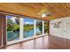Living room features hardwood floors, wood ceiling, large windows offering panoramic water views at 6406 Lincoln Rd, Bradenton, FL 34203