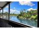 Covered porch with black wood rails overlooking scenic waterfront views at 6406 Lincoln Rd, Bradenton, FL 34203