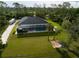 Aerial shot of backyard and enclosed pool with hot tub and recreational area at 6713 Taneytown St, North Port, FL 34291