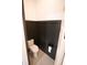 This half-bathroom features dark wainscoting, white walls, a toilet, and toilet paper holder at 6713 Taneytown St, North Port, FL 34291