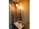 Modern bathroom boasts a sleek vanity with a unique mirror and stylish lighting at 6713 Taneytown St, North Port, FL 34291