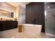 Bright and modern bathroom featuring a freestanding tub and separate glass-enclosed showers at 6713 Taneytown St, North Port, FL 34291