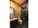 Modern bathroom features sleek vanity, unique lighting, and luxurious marble walk-in shower at 6713 Taneytown St, North Port, FL 34291