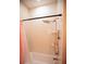 Bright bathroom featuring a shower-tub combo with gold fixtures and a pink shower curtain at 6713 Taneytown St, North Port, FL 34291