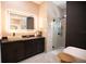 Modern bathroom features a stone sink, sleek vanity and glass enclosed shower at 6713 Taneytown St, North Port, FL 34291