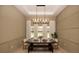 Dining room with neutral paneled walls, modern lighting, and backyard views at 6713 Taneytown St, North Port, FL 34291