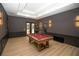 Relax in this game room with a pool table and convenient access to the outdoor pool area at 6713 Taneytown St, North Port, FL 34291